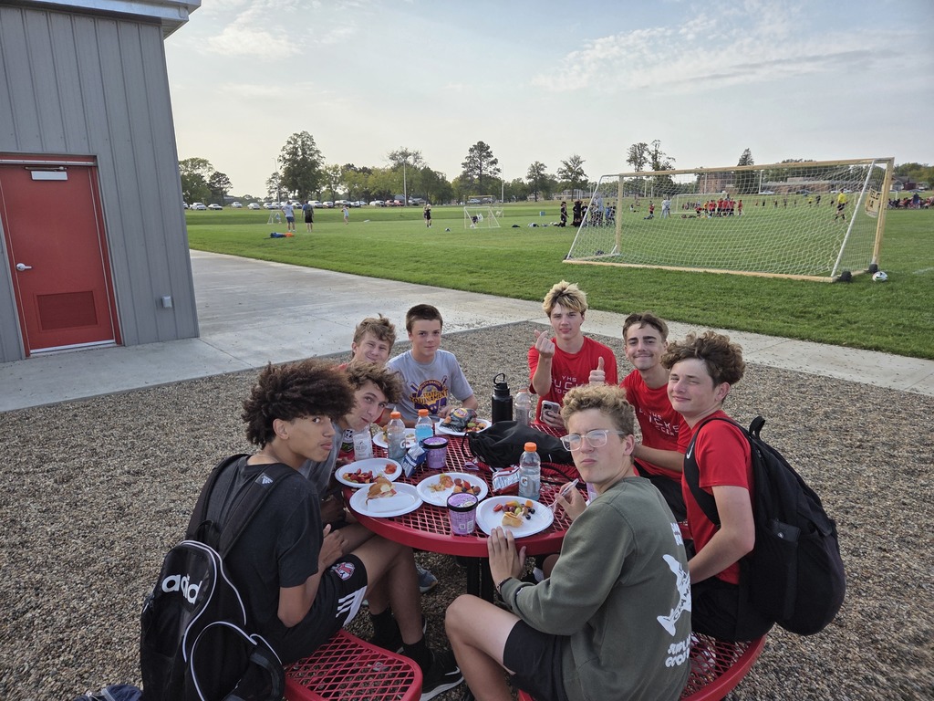 Boys enjoying sandwiches and ice-cream.