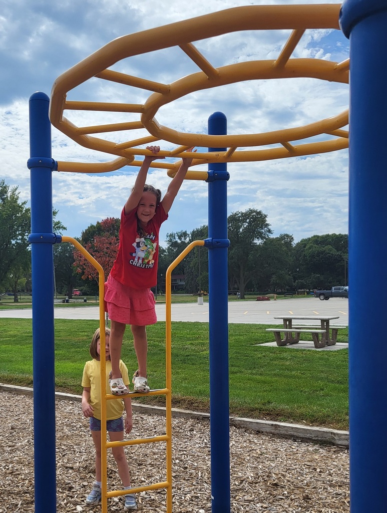 2 girls on jungle gym