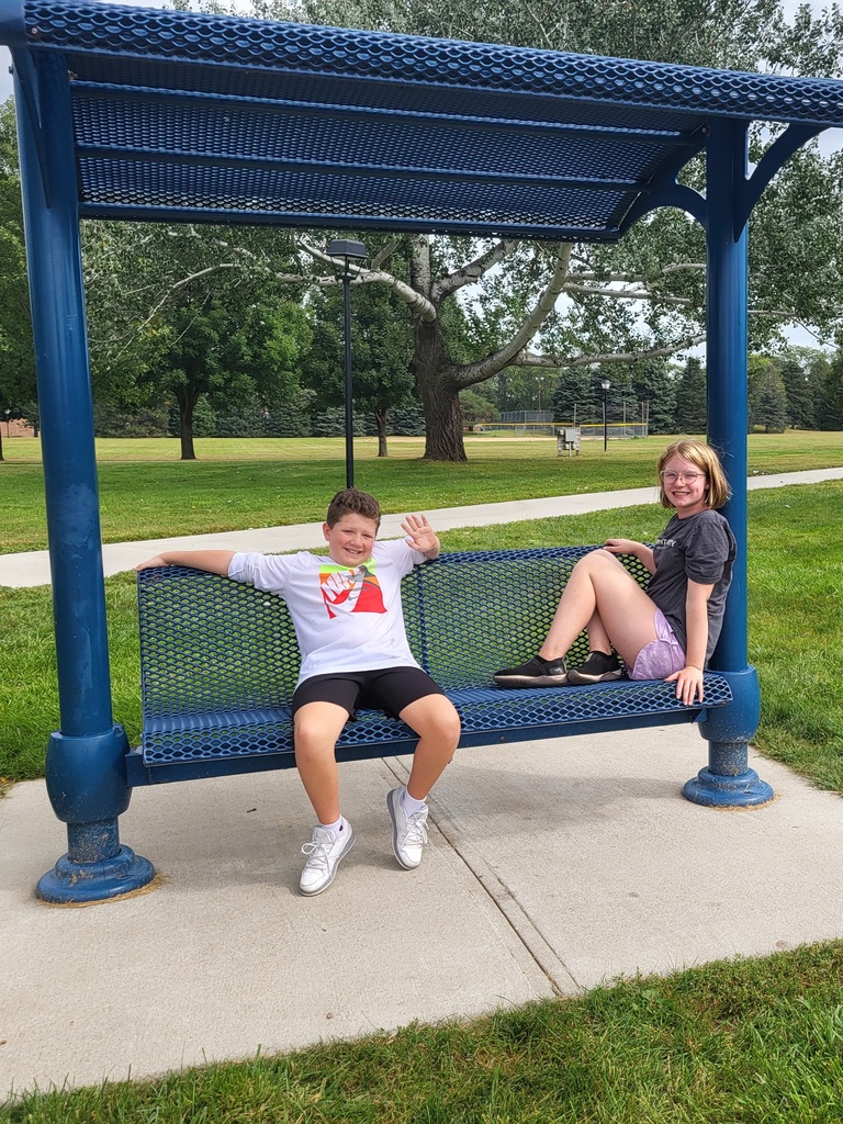 2 kids on a blue bench