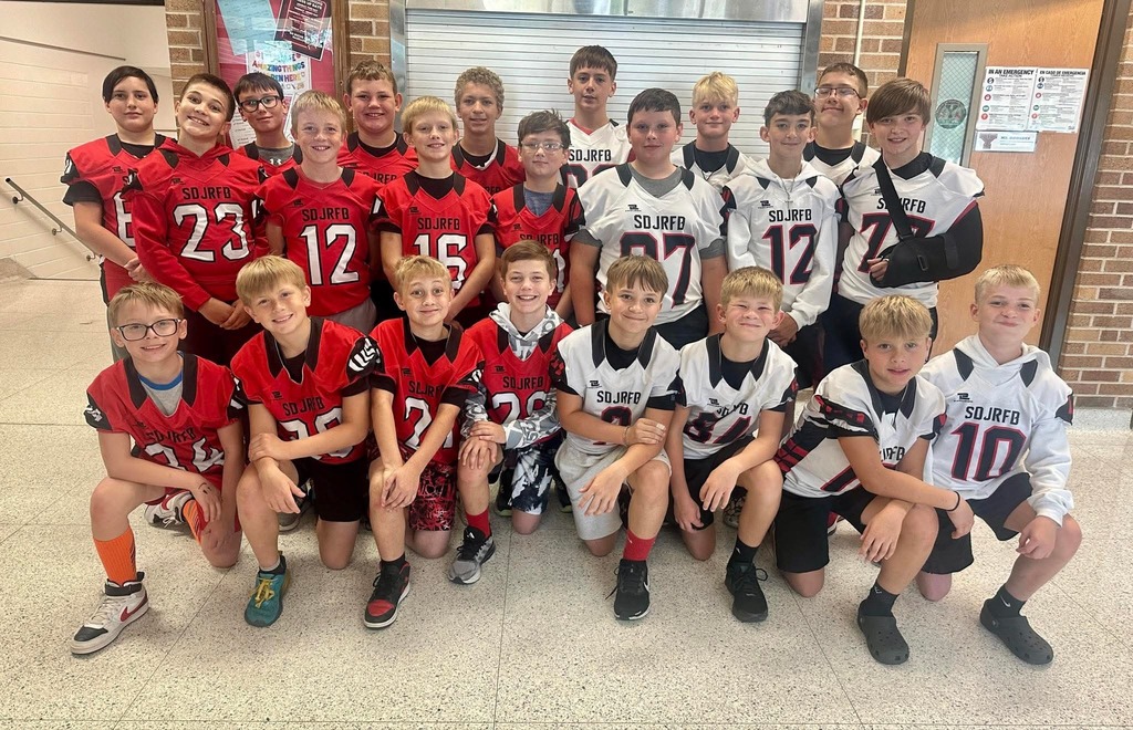 6th grade football players in their uniforms