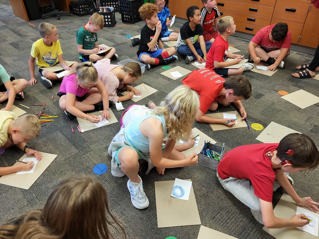 group of kids drawing on floor