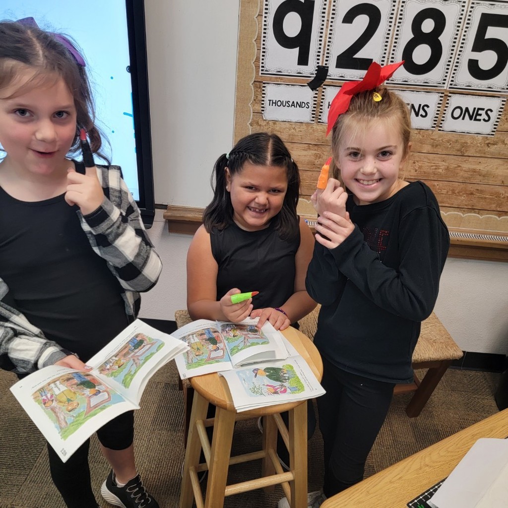 students reading with witch fingers