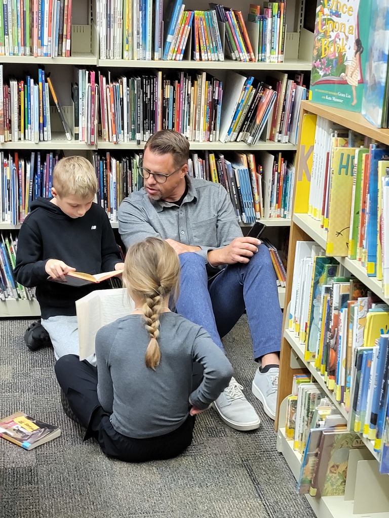 Boy and girl reading to dad