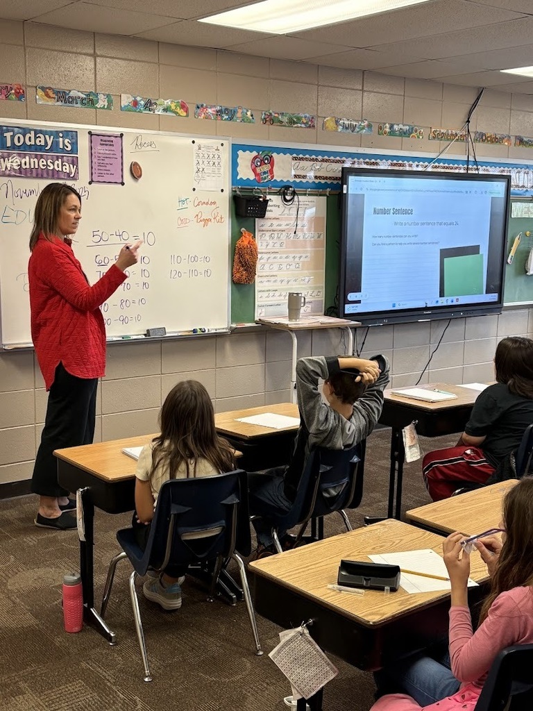 Mrs. Valnes from YSD playing a number game with the 4th graders!