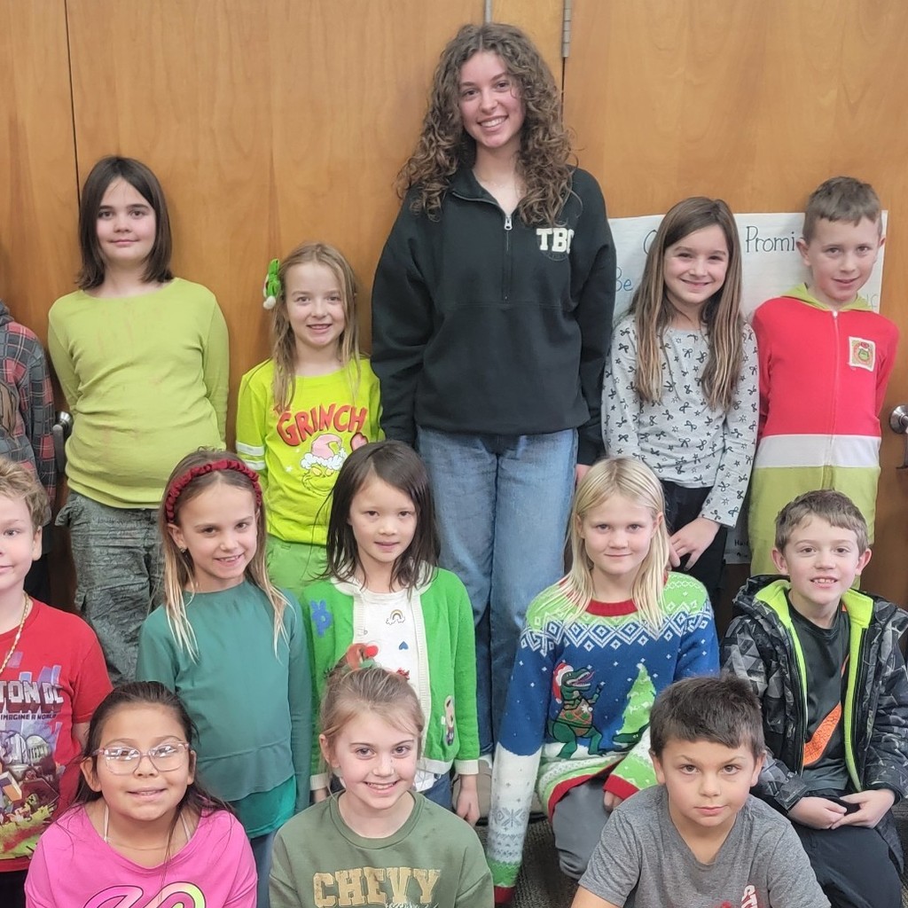Students standing with their high school intern.