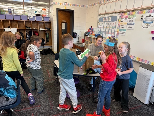 Students are giving Eva hugs and cards