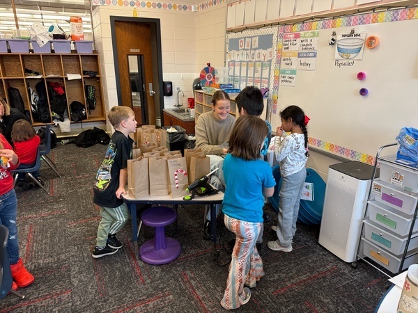 Students are giving Eva hugs and cards