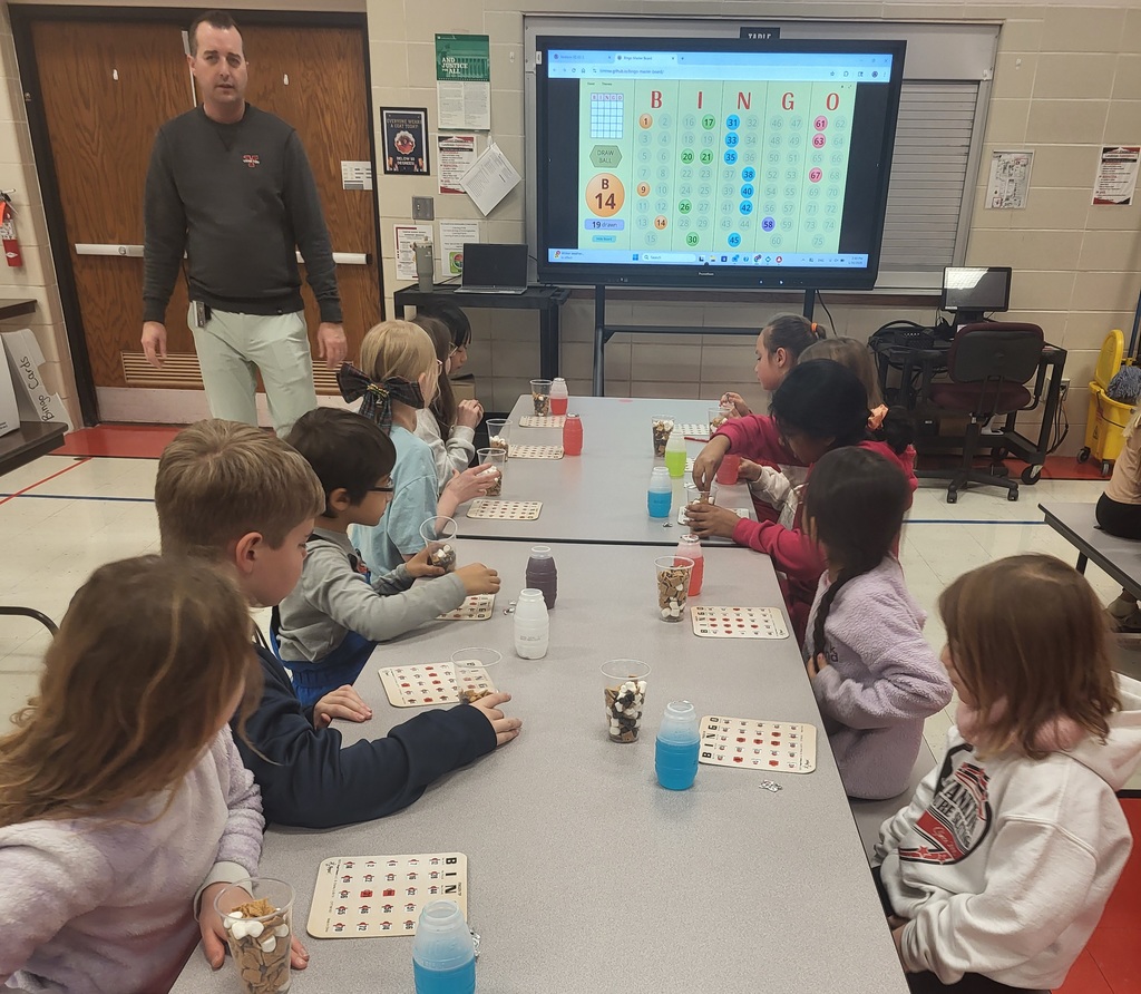 Students seated at table playing bingo