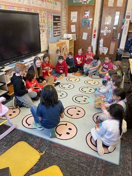 students with teacher for kindness lesson