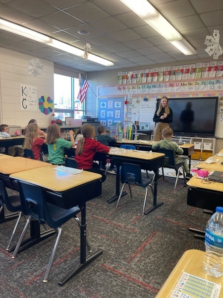 students with teacher for kindness lesson