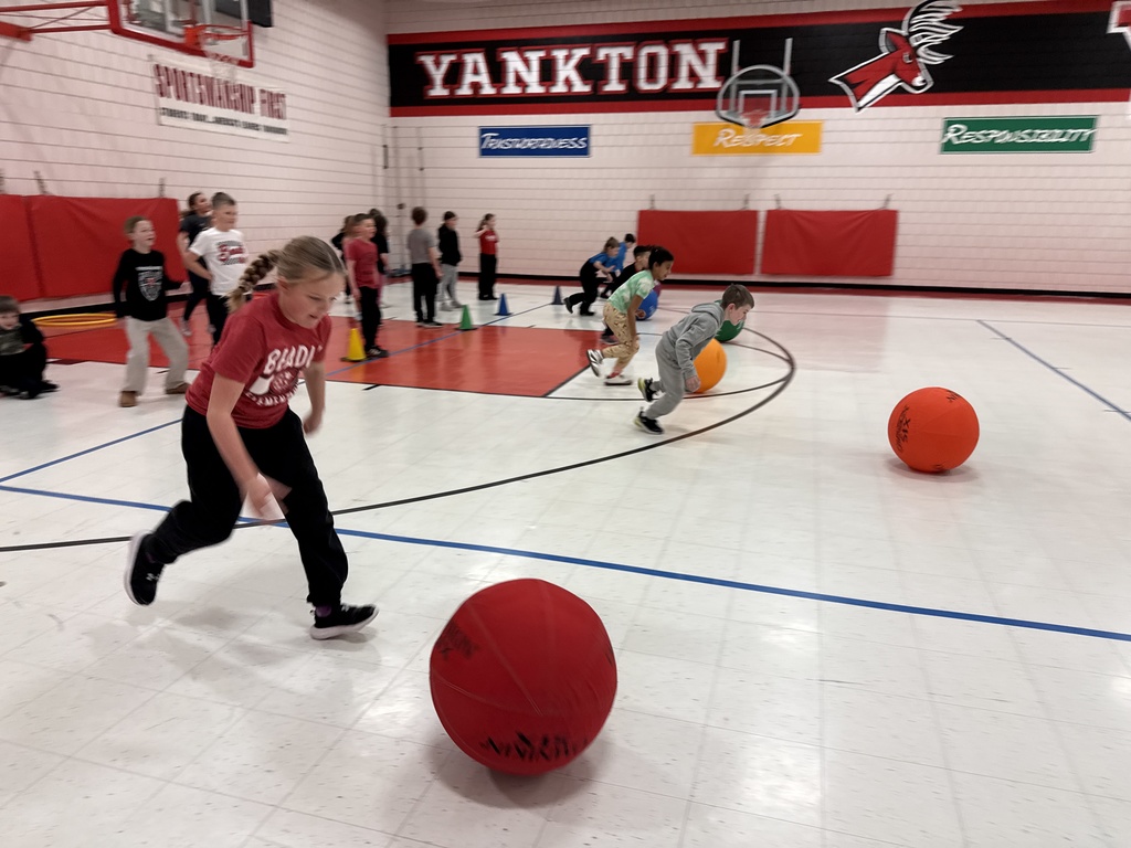 Students pushing a large ball