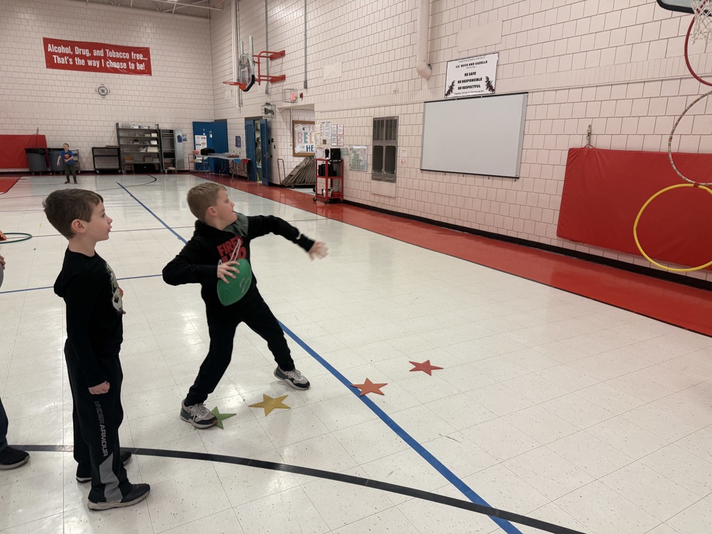 student throwing football