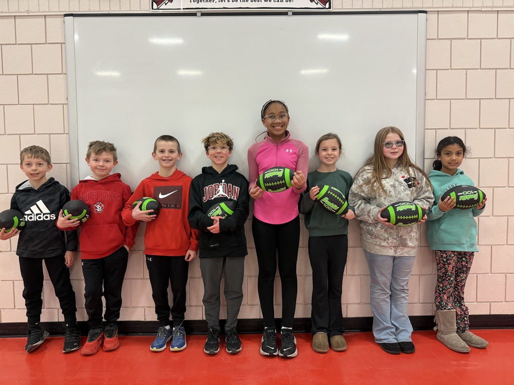 Students holding footballs