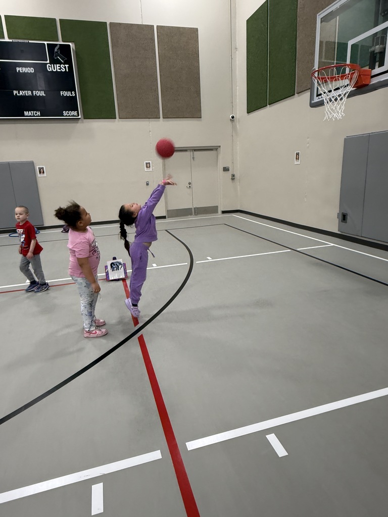 Student shooting baskets.