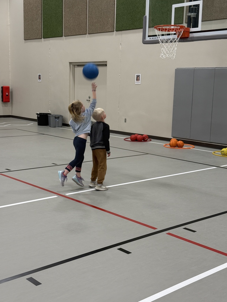 Student shooting baskets.
