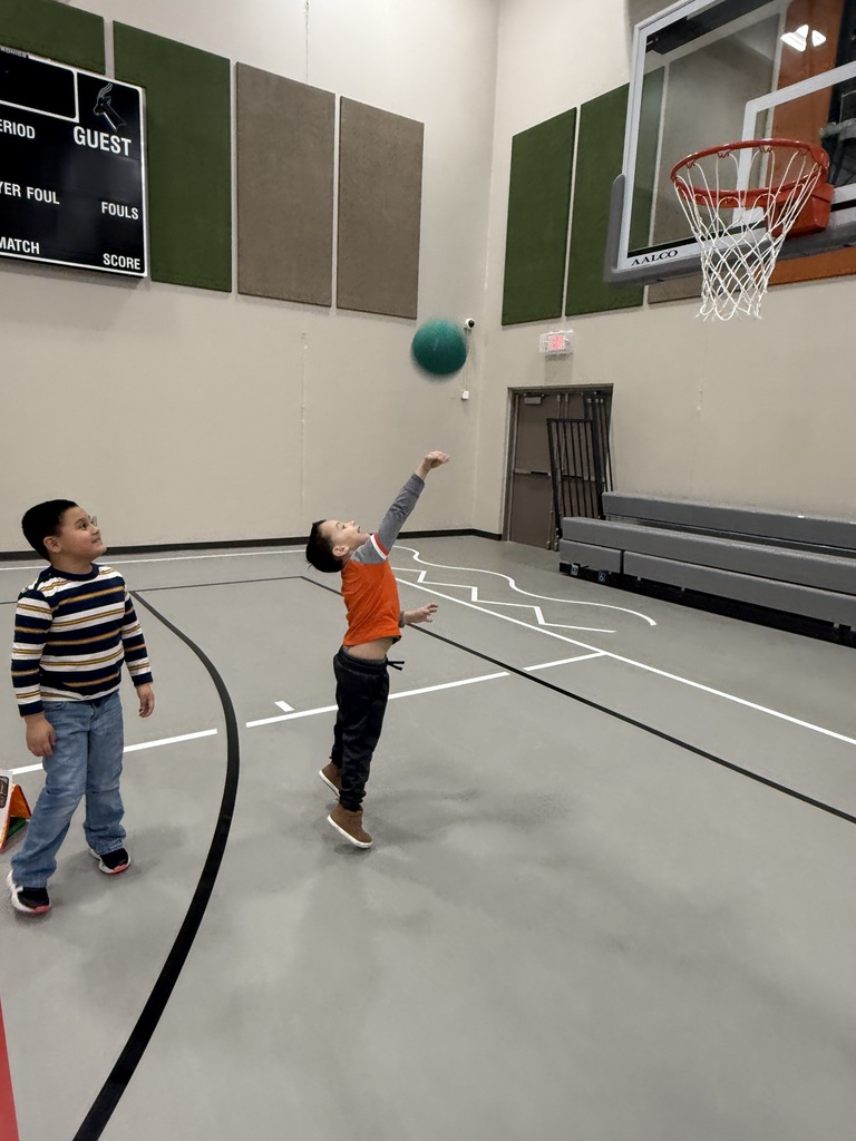 Student shooting baskets.