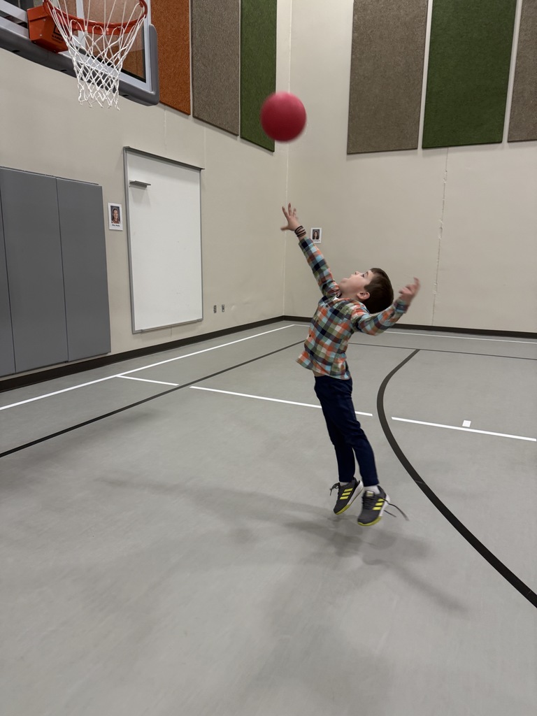 Student shooting baskets.