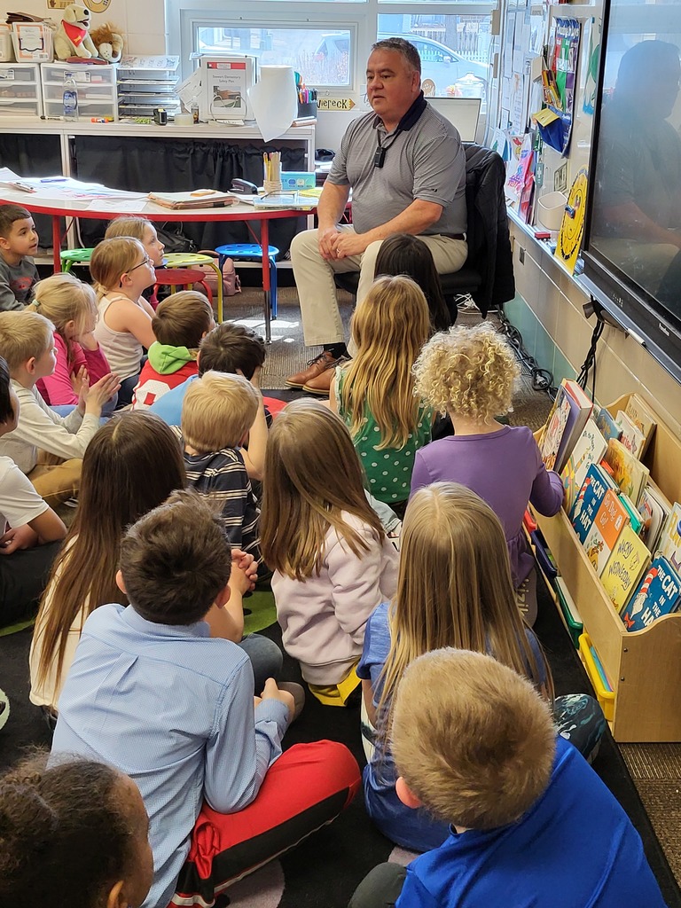 Man talking with students seated on floor
