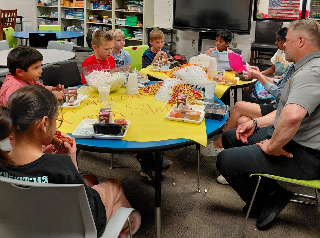 man and students eating at tables