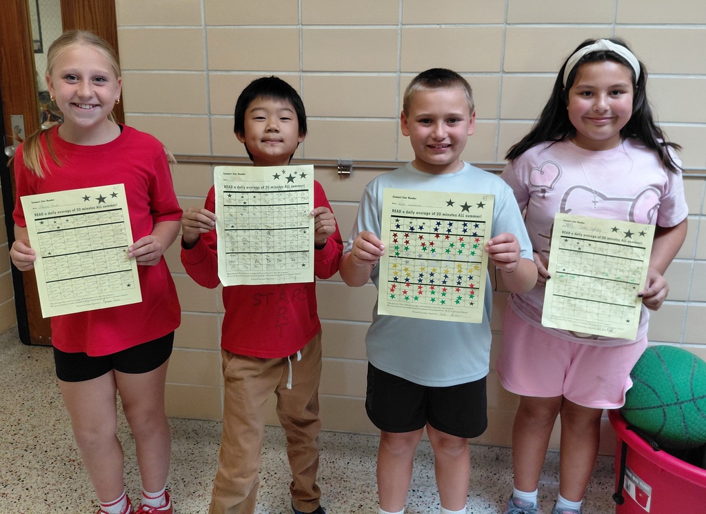 4 children holding papers
