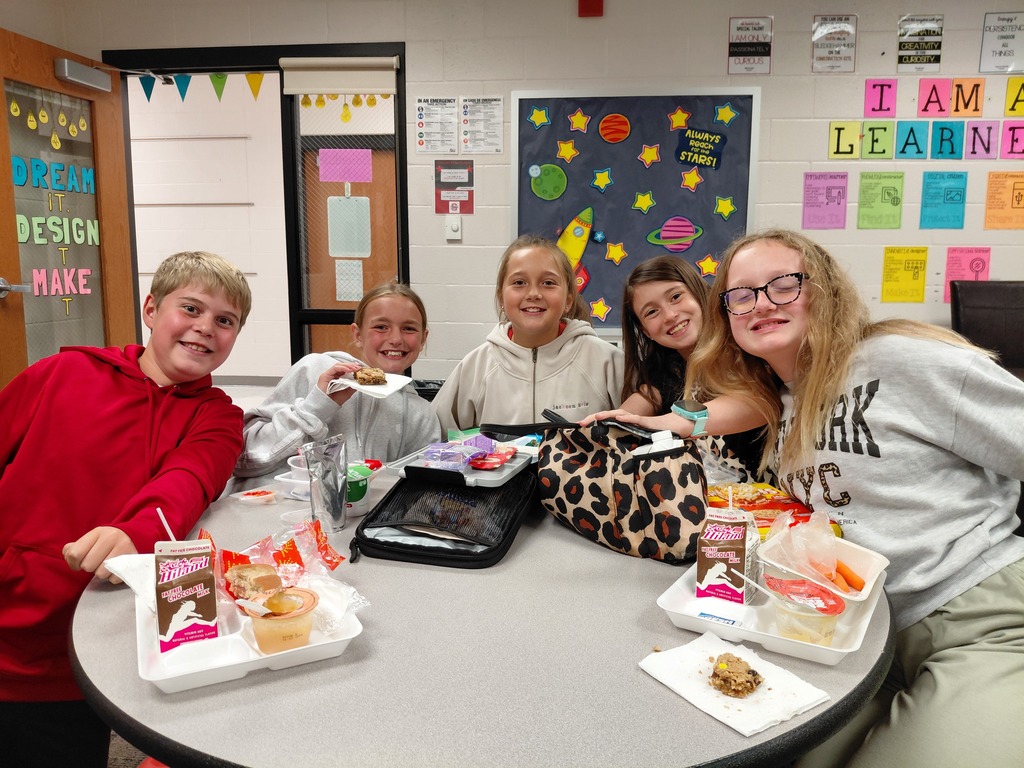 5 kids eating around a table