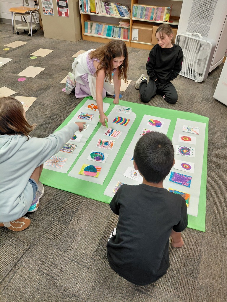 4 students spraying art on floor