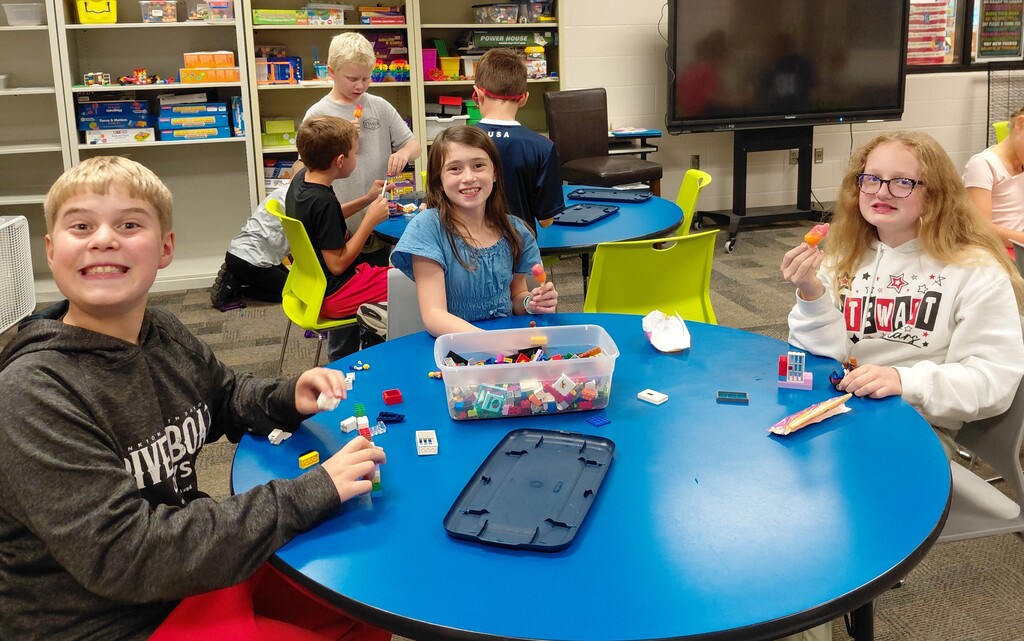 kids at tables building with legos