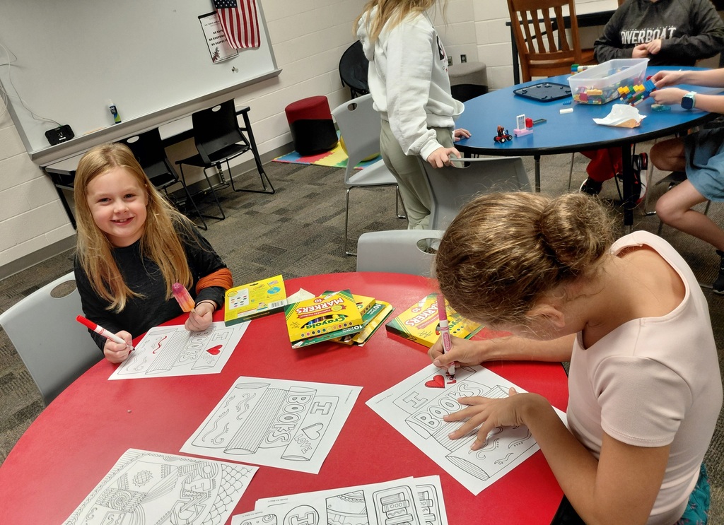 2 seated girls coloring