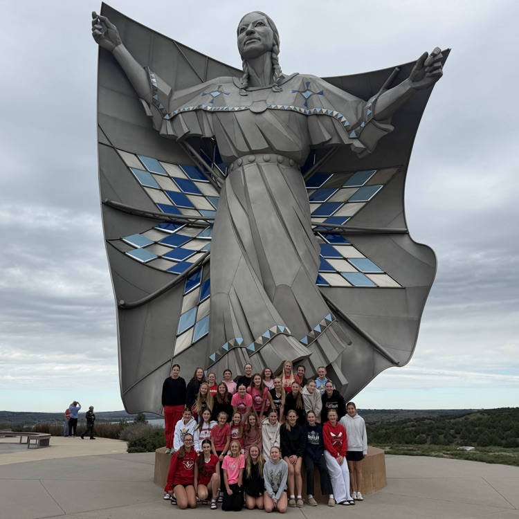 Gazelle seventh and eighth grade volleyball players stopped to take a picture with Dignity of Earth and Sky on the way to their match in Pierre.