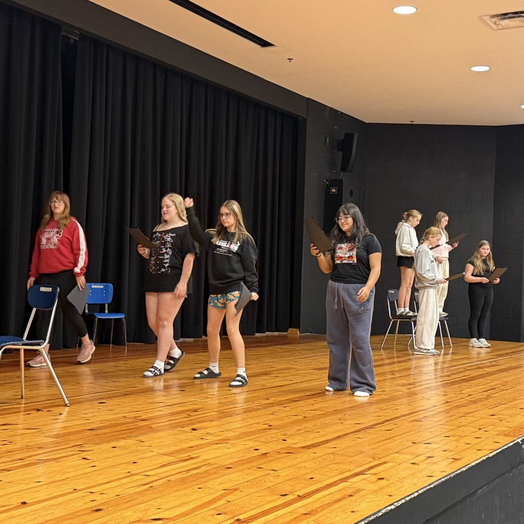 students practice performances on stage