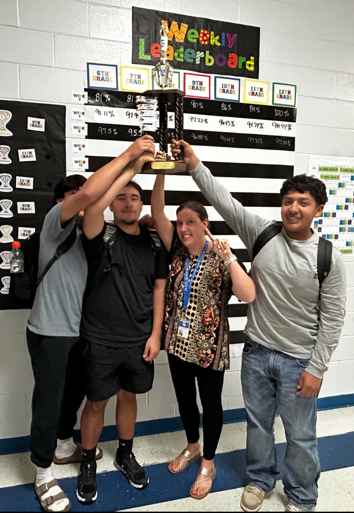 students and adult holding trophy