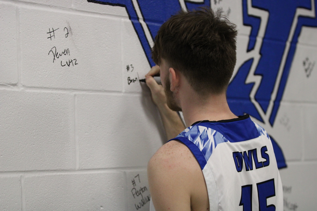 student signing wall