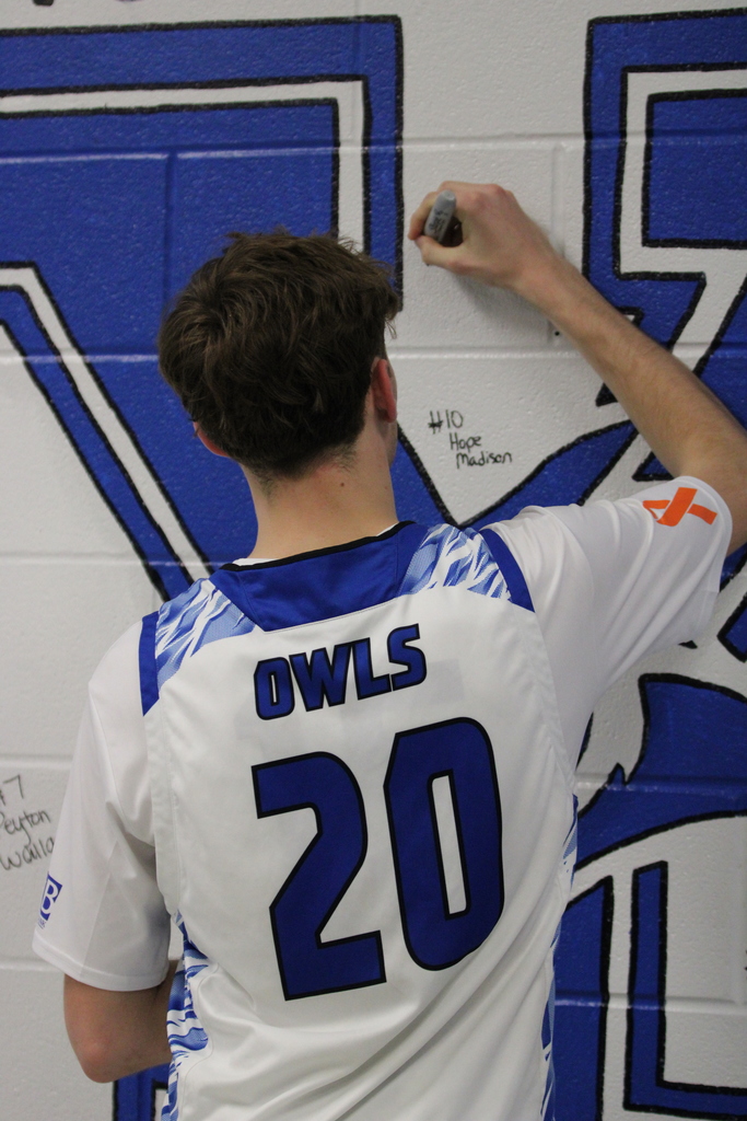 student signing wall