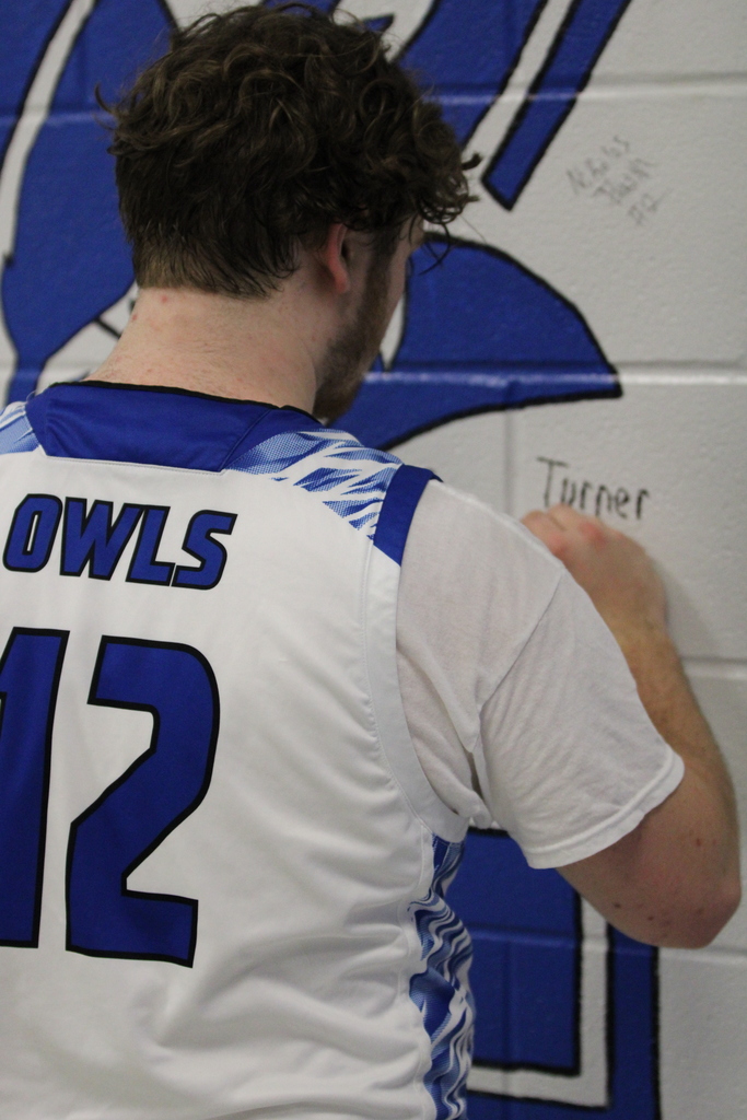 student signing wall