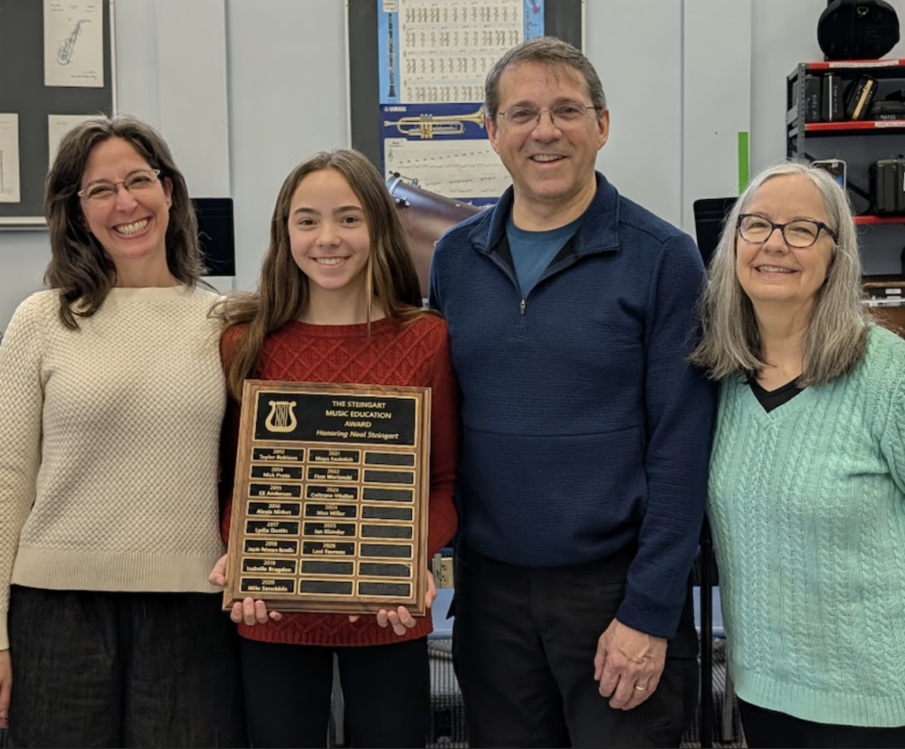 Student and family with plaque