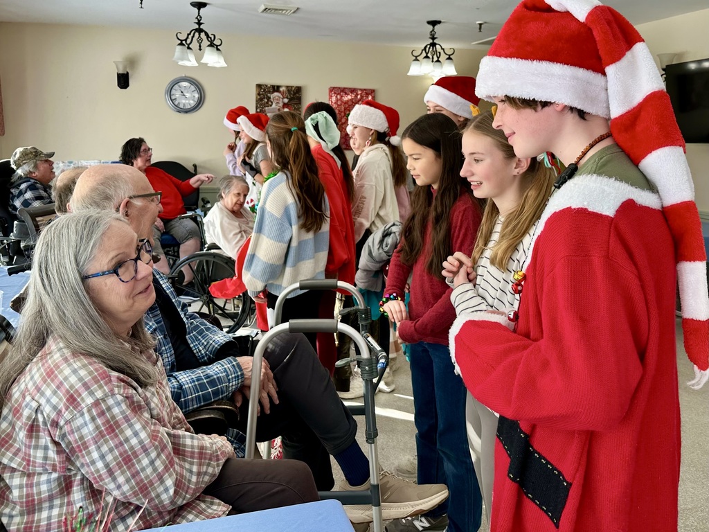 6th-grade a capella members talking with nursing home residents