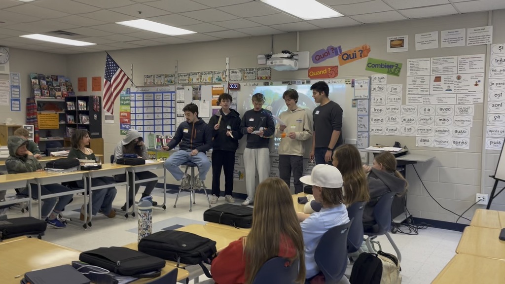 YHS students perform songs in French for seventh grade French students at HMS