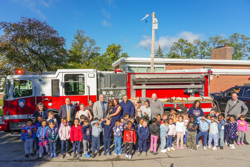 Students pose in front of firetruck