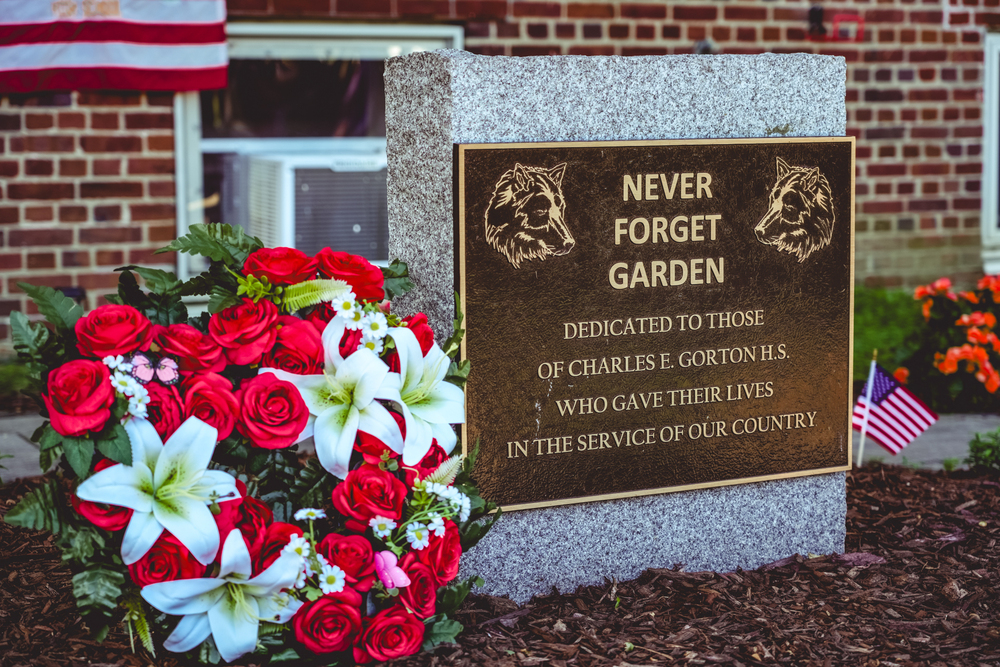 Never Forget Garden monument and red and white flowers