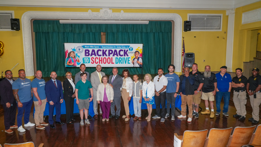 Group posing at the Mayor's Backpack to school drive event