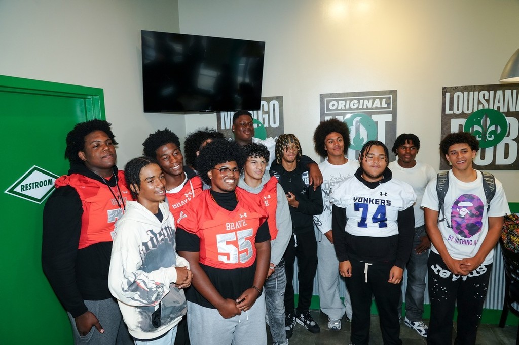 Yonkers Brave and Yonkers Force Football Players Take a Picture at the Wingstop Grand Opening 