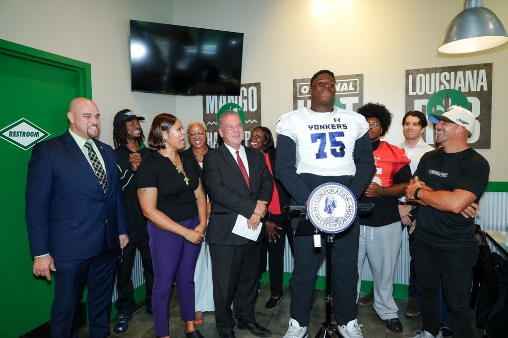 A Yonkers Force Football Player Speaking at the Wingstop Grand Opening 