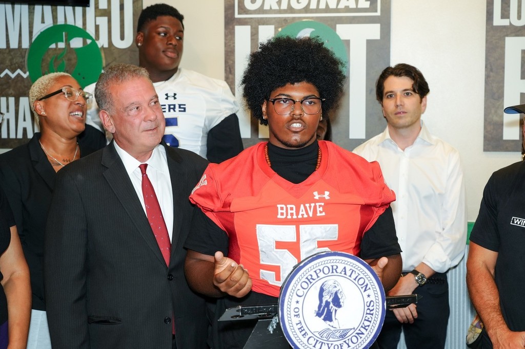 A Yonkers Brave Football Player Speaking at the Wingstop Grand Opening 