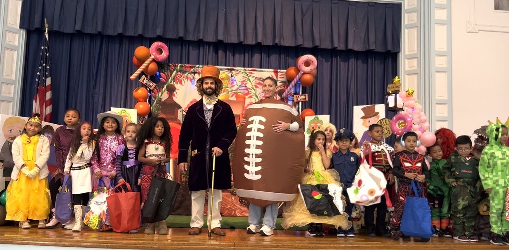 Ms. Miralles and students on stage