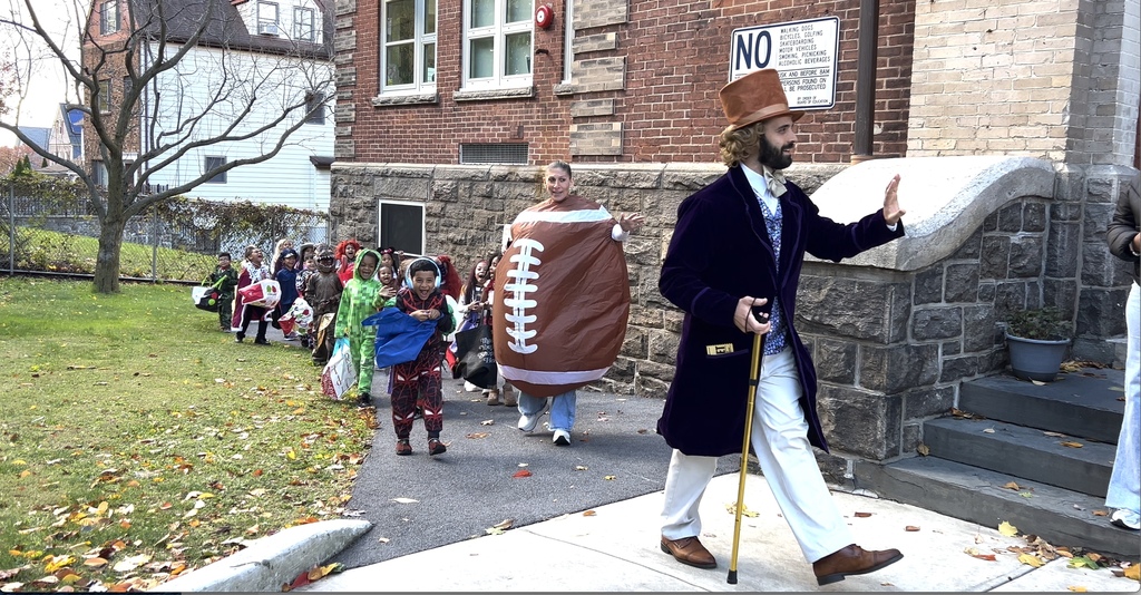 Mr. Cartica leading students around the building