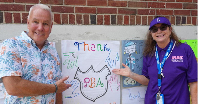 Principal Murphy and Associate Superintendent Judon flank student posters thanking the PBA for all they do for the Extended School Year Program