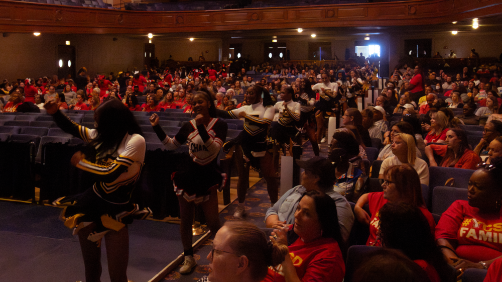 cheerleaders in auditorium surrounded by crowd