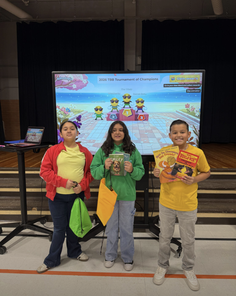 3 students showing their prize books