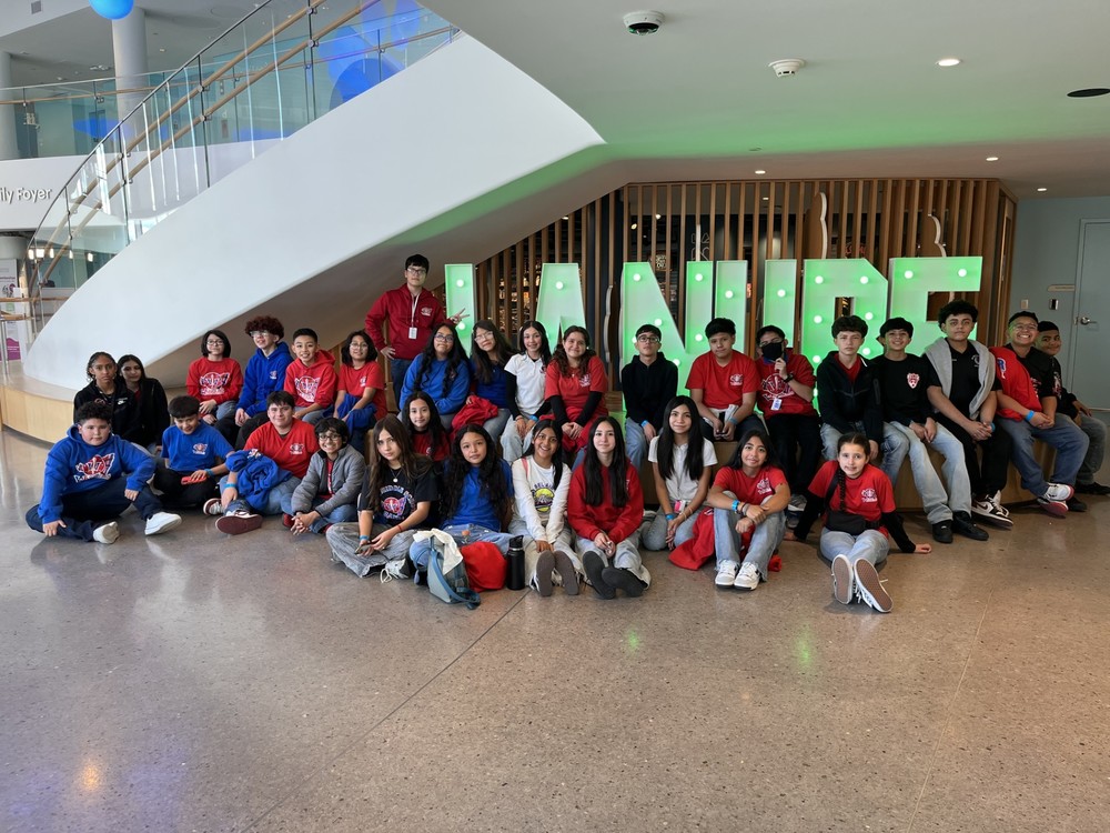 Library Students posing in front of La Nube sign