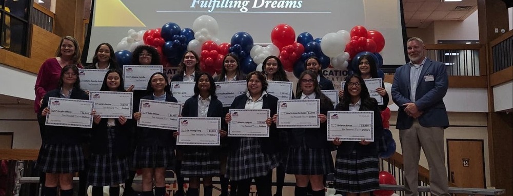 YEF scholarship winners on stage at central office